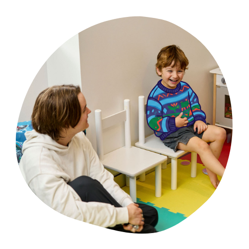Young person with child in jumpers