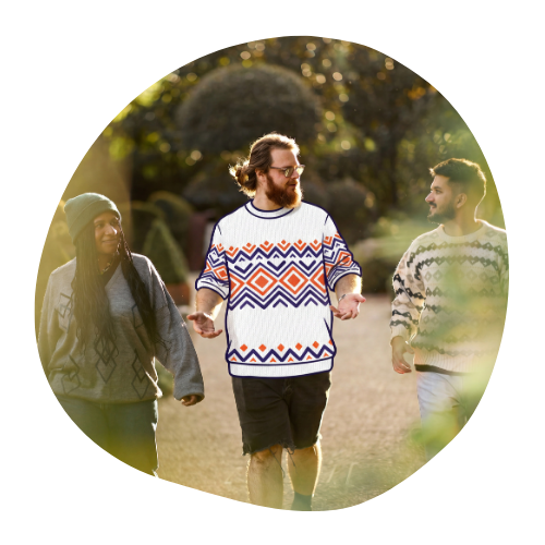 Three people walking and talking in jumpers