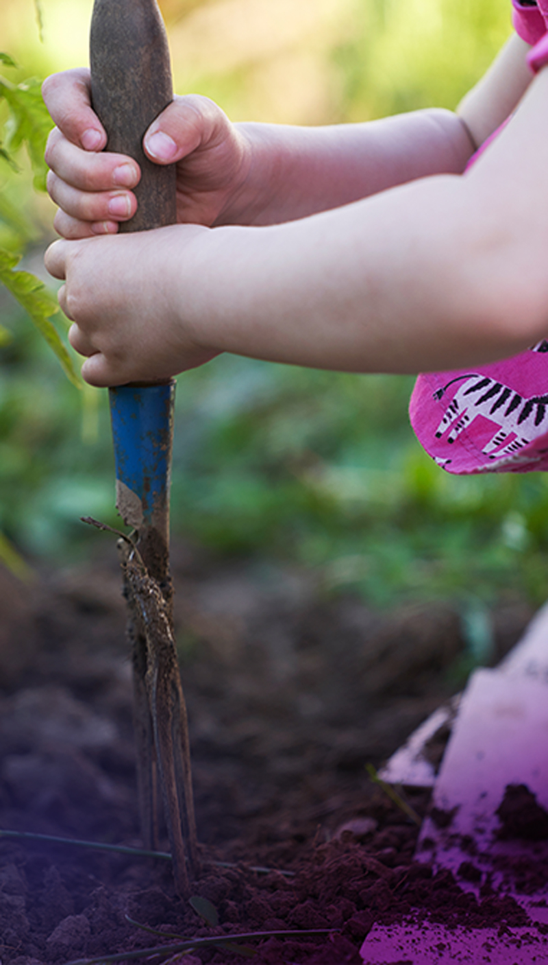 young girl digs a garden